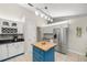 Bright kitchen featuring stainless steel appliances, white cabinets, and a charming movable center island at 719 Ne 39Th St, Ocala, FL 34479