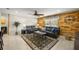 Stylish living room featuring a wood paneled wall, ceiling fan, and comfortable seating at 719 Ne 39Th St, Ocala, FL 34479
