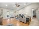 Cozy living room with hardwood floors, ceiling fan, and ample natural light at 719 Ne 39Th St, Ocala, FL 34479