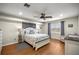 Main bedroom with hardwood floors, ceiling fan, and plenty of natural light at 719 Ne 39Th St, Ocala, FL 34479