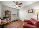 Functional home office with a desk, leather couch, shelving, and natural light, ideal for work or study at 719 Ne 39Th St, Ocala, FL 34479