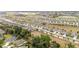 Extensive aerial view showing a community with closely spaced houses and mature trees at 8090 Penrose Pl, Wildwood, FL 34785