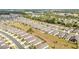 An aerial view of a residential area featuring uniform rooftops, landscaped yards, and a grid-like street layout at 8090 Penrose Pl, Wildwood, FL 34785