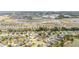 Aerial view depicts a residential area with a nearby pond and multiple community facilities at 8090 Penrose Pl, Wildwood, FL 34785