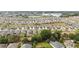 Vast aerial panorama presents a community near a lake, featuring organized streets and homes at 8090 Penrose Pl, Wildwood, FL 34785