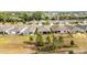 An aerial view of single-Gathering homes featuring well-maintained landscaping and backyard patios in a quiet neighborhood at 8090 Penrose Pl, Wildwood, FL 34785