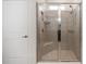Glass-enclosed shower features bench seat, tiled walls and floor, and dual shower heads at 8090 Penrose Pl, Wildwood, FL 34785