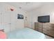 Well-lit bedroom with a double closet, ceiling fan and light blue comforter at 8090 Penrose Pl, Wildwood, FL 34785