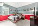 A bedroom featuring a ceiling fan, grey and red color theme, and carpeted floors at 8090 Penrose Pl, Wildwood, FL 34785