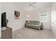 Cozy bedroom with a ceiling fan, soft carpet, and a comfortable grey sofa at 8090 Penrose Pl, Wildwood, FL 34785