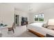 Bright bedroom with carpet features large window, ceiling fan, and TV atop dark wood entertainment center at 8090 Penrose Pl, Wildwood, FL 34785