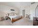 Comfortable bedroom boasts neutral color palette and carpet, a ceiling fan, and a dedicated desk space at 8090 Penrose Pl, Wildwood, FL 34785