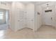Well lit hallway with tile floors and storage closets, creating a seamless transition at 8090 Penrose Pl, Wildwood, FL 34785