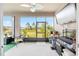 Enclosed lanai with TV offers a relaxed living space with views of the neighborhood at 8090 Penrose Pl, Wildwood, FL 34785