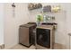 Efficient laundry room equipped with modern washer and dryer and ample shelving for storage at 8090 Penrose Pl, Wildwood, FL 34785