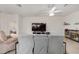 Open-concept living area with ceiling fan, tile floors, and neutral colored walls at 8090 Penrose Pl, Wildwood, FL 34785