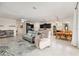 Open living space features a cozy seating area, adjacent to a kitchen and dining area at 8090 Penrose Pl, Wildwood, FL 34785