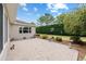 Back patio with brick pavers, decorative elements and a view of manicured landscaping at 8955 Sw 86Th Loop, Ocala, FL 34481