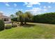Spacious backyard with green lawn, mature trees, and meticulously maintained privacy hedges at 8955 Sw 86Th Loop, Ocala, FL 34481