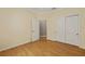 Bright bedroom with hardwood floors, white trim, and double closet for ample storage at 8955 Sw 86Th Loop, Ocala, FL 34481