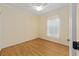 Cozy bedroom with light walls, hardwood floors, ceiling fan, and bright natural light at 8955 Sw 86Th Loop, Ocala, FL 34481