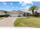 Charming home with a brick driveway, two-car garage, and well-maintained landscaping at 8955 Sw 86Th Loop, Ocala, FL 34481