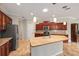 Spacious kitchen featuring stainless steel appliances, granite countertops, a large island, and custom cabinetry at 8955 Sw 86Th Loop, Ocala, FL 34481