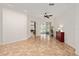 Open-concept living area featuring tile floors, neutral walls, and sliding glass doors to the screened-in patio at 8955 Sw 86Th Loop, Ocala, FL 34481