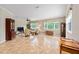 Living room features neutral walls, tile flooring, and windows with natural views at 8955 Sw 86Th Loop, Ocala, FL 34481