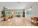 Comfortable living room offering tile flooring, large windows with natural light, and neutral colored walls at 8955 Sw 86Th Loop, Ocala, FL 34481