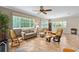 Cozy living room with tile flooring, neutral walls, and large windows for natural light and views at 8955 Sw 86Th Loop, Ocala, FL 34481