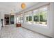 Sunroom offering lots of natural light and backyard garden views with ceiling fans to provide a relaxing space at 8955 Sw 86Th Loop, Ocala, FL 34481