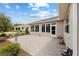 Backyard patio with brick pavers, mature plantings and a door to the sunroom at 8955 Sw 86Th Loop, Ocala, FL 34481
