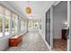 Enclosed patio with patterned tile, multiple windows, and sliding doors for indoor/outdoor living at 8955 Sw 86Th Loop, Ocala, FL 34481