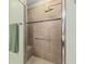 Modern shower with tiled walls, rainfall showerhead, and built-in bench seating at 8955 Sw 86Th Loop, Ocala, FL 34481
