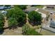 Aerial view of home situated among mature trees with detached garage and driveway at 9885 Se 144Th St, Summerfield, FL 34491