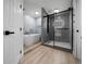 Relaxing bathroom design with soaking tub, walk-in shower, and wood-look flooring at 9885 Se 144Th St, Summerfield, FL 34491