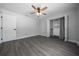 Bedroom featuring a ceiling fan, neutral walls, wood-look floors, and a closet system at 9885 Se 144Th St, Summerfield, FL 34491