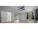 Bedroom features wood-look floors, ceiling fan, and sliding glass doors to the patio at 9885 Se 144Th St, Summerfield, FL 34491