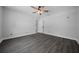 Neutral bedroom with luxury vinyl plank flooring, light walls, and a ceiling fan at 9885 Se 144Th St, Summerfield, FL 34491