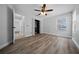 Bright bedroom with a closet system, ceiling fan, light walls, and wood-look flooring at 9885 Se 144Th St, Summerfield, FL 34491