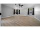 Spacious bedroom with wood-look flooring, a ceiling fan, and natural light from windows at 9885 Se 144Th St, Summerfield, FL 34491
