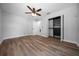 Bedroom features wood-look floors, ceiling fan, and a closet with built-in shelving at 9885 Se 144Th St, Summerfield, FL 34491