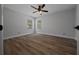 Bright bedroom featuring wood-look floors, ceiling fan, and natural light at 9885 Se 144Th St, Summerfield, FL 34491
