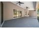 The outdoor covered patio has three ceiling fans and sliding glass doors leading indoors at 9885 Se 144Th St, Summerfield, FL 34491