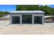 Metal building with three bays, an automotive lift, tool box, and concrete drive, offering ample workspace at 9885 Se 144Th St, Summerfield, FL 34491