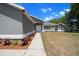 A gray home with fresh landscaping around the front of the property at 9885 Se 144Th St, Summerfield, FL 34491