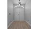 The front entryway of this home features double doors and wood floors at 9885 Se 144Th St, Summerfield, FL 34491