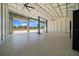 Spacious metal garage interior with car lift, rolling doors, and epoxy floor, providing a functional workspace at 9885 Se 144Th St, Summerfield, FL 34491