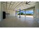 Spacious garage featuring an epoxy floor, two car lifts and two bay doors to the outdoors at 9885 Se 144Th St, Summerfield, FL 34491